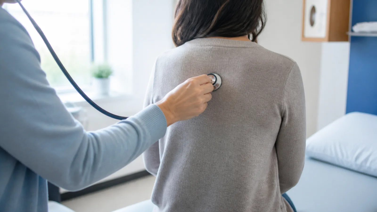 A healthcare professional listening to a patient's breathing with a stethoscope